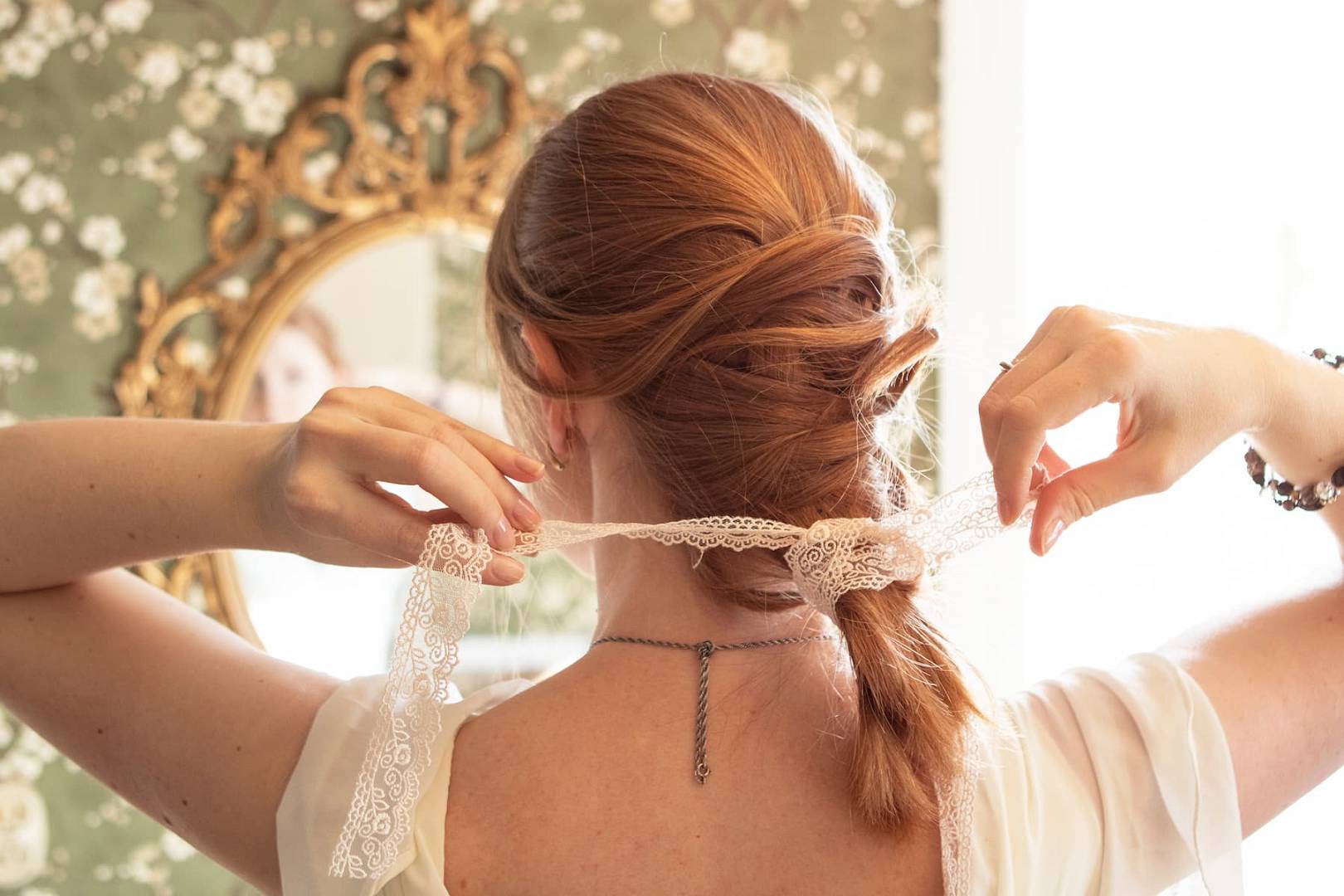 woman-styling-hair-with-ribbon-in-bedroom-2026-03-16-01-21-05-utc(1).jpg